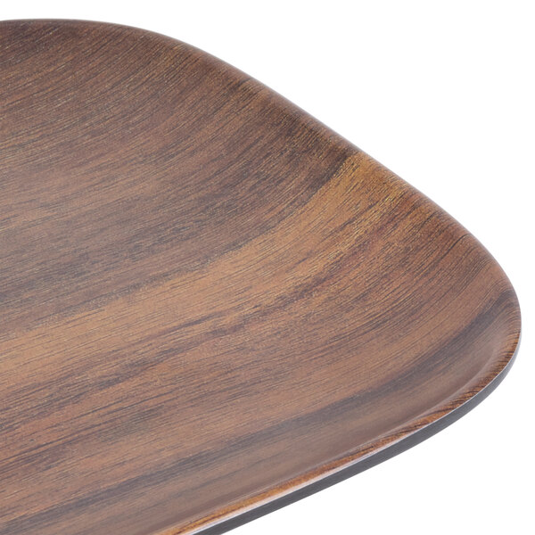 A Carlisle rectangular melamine tray with a woodgrain design.