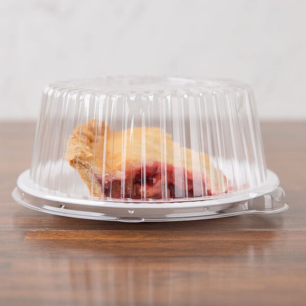 A piece of pie in a Dart clear plastic container with a clear lid.