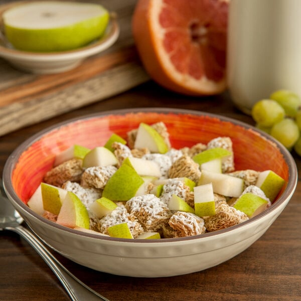 A Carlisle Fireball melamine cereal bowl filled with cereal and fruit.