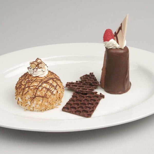 A white plate with a dessert made using an Ateco stainless steel round cake mold.