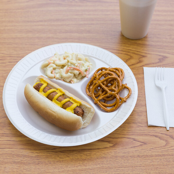 A Dart Concorde foam plate with a hot dog, pretzels, and a drink on a table.