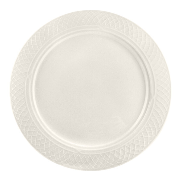 A round, ivory-colored plate with a textured, lattice-like pattern around the rim.