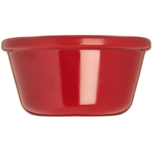 A close-up of a red Carlisle Roma melamine ramekin.