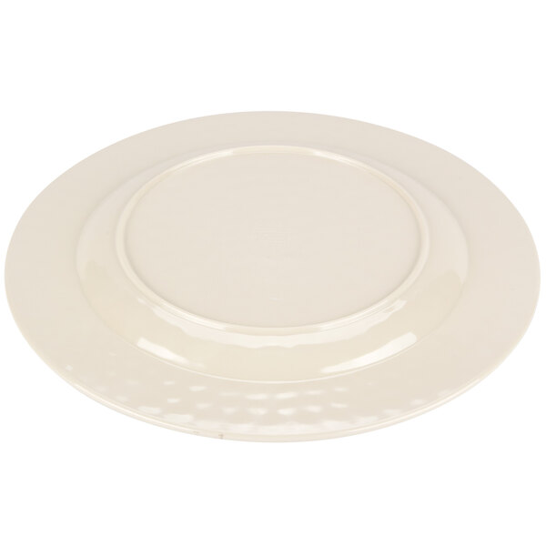 A white Carlisle melamine plate with a round rim.