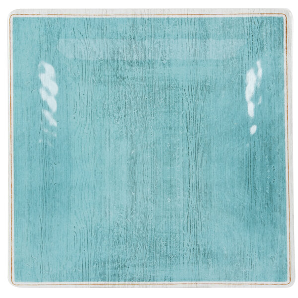 A blue square Carlisle melamine salad plate with a white border.