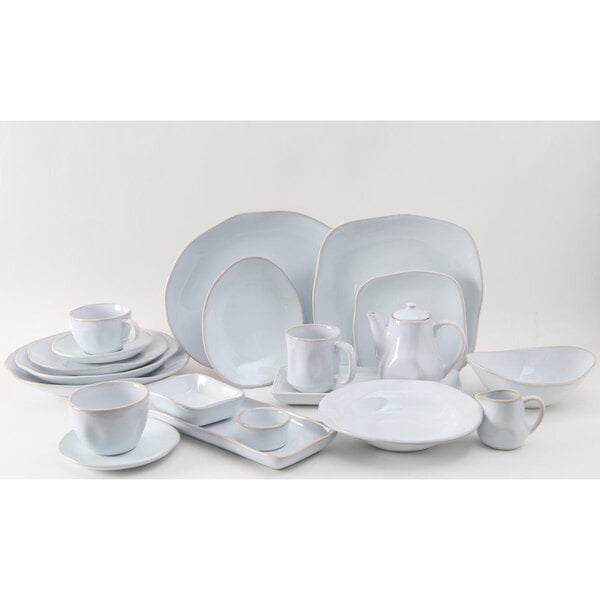 A group of Tuxton Artisan Agave white plates.