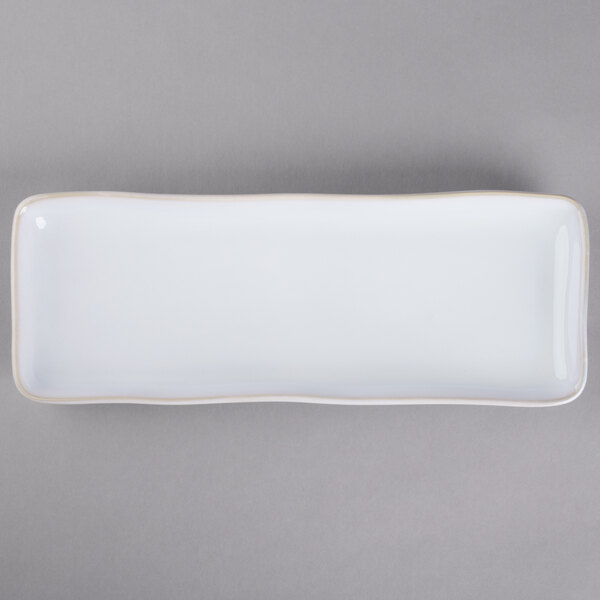 A white rectangular china tray with a thin black border.