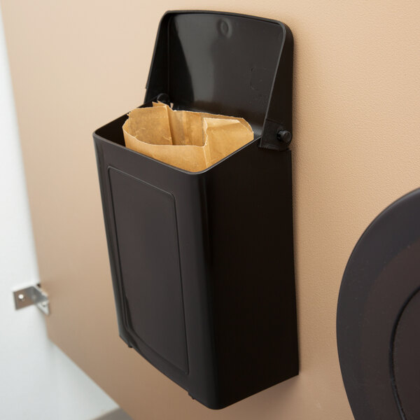 A black Lavex wall-mount sanitary napkin receptacle with a brown paper bag inside.