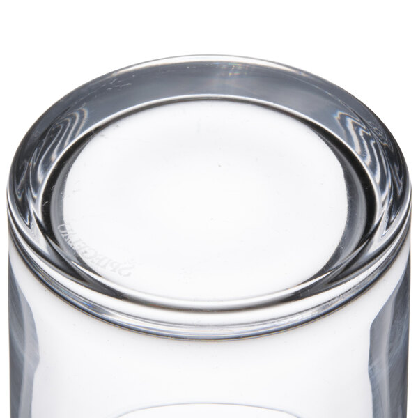 A close up of a clear Spiegelau whiskey glass with a small circular design.