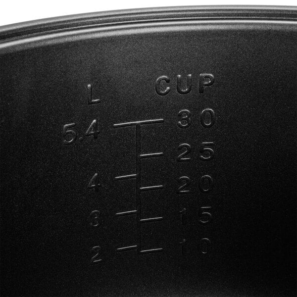 A black Proctor Silex measuring cup with a non-stick white interior.