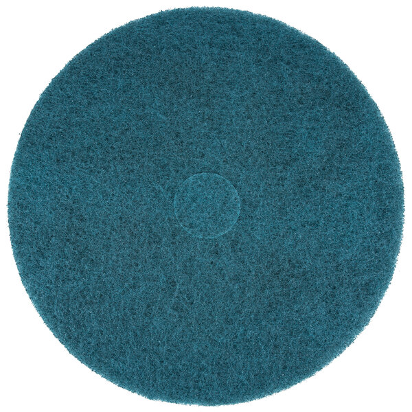 A 3M blue circular floor pad with a circle in the middle.
