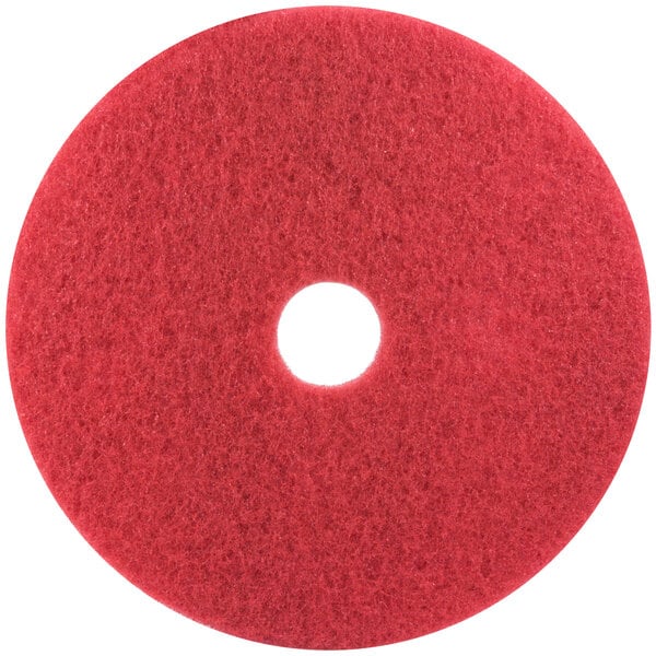 A 3M red circular buffing pad with a white center.