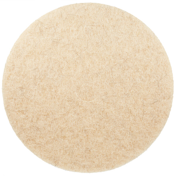 A round tan felt pad with a white background.