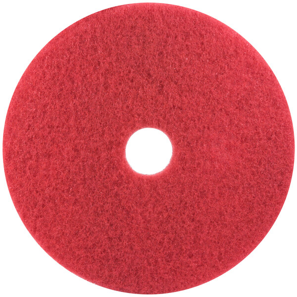 A 3M red circular buffing pad with a white center.