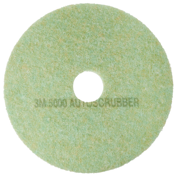 A white circular pad with a green background and a hole in the middle.