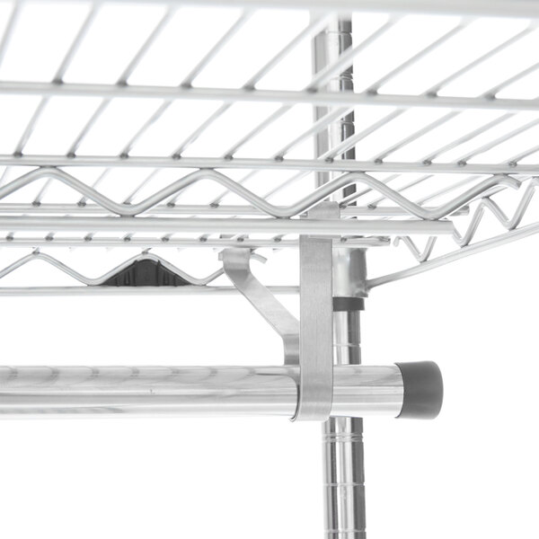 A close-up of a Metro garment hanger tube attached to a metal shelf.