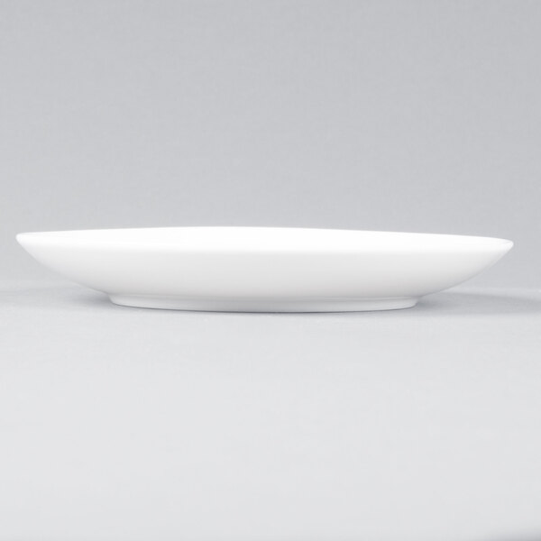 An Arcoroc white porcelain B&B plate with a small rim.
