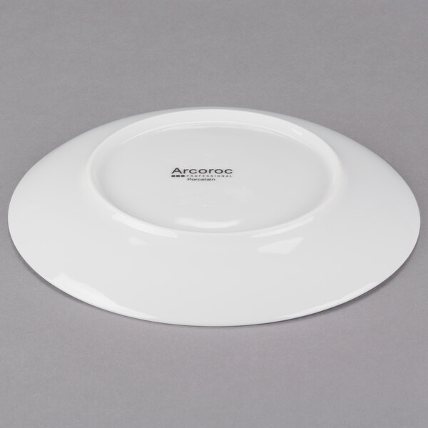 A white porcelain salad plate with a round bottom and a white rim.