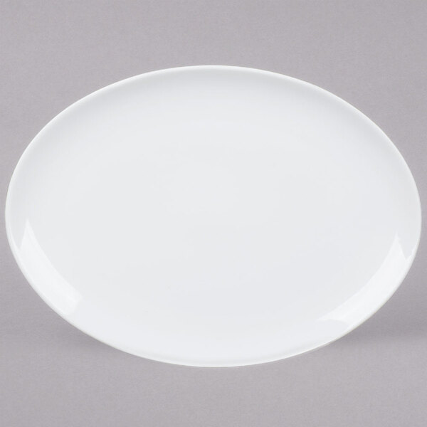 A white Arcoroc oval porcelain platter on a gray surface.