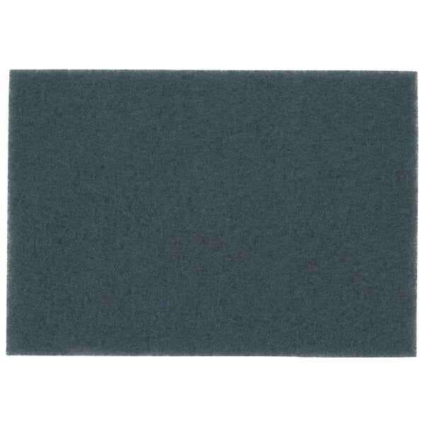 A blue rectangular 3M cleaner pad.