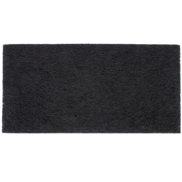 A close-up of a black rectangular 3M stripping pad.