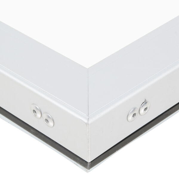 A close up of a white frame with two metal screws.