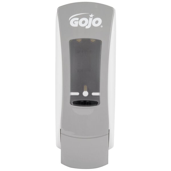 A gray GOJO® ADX-12 manual soap dispenser with a clear plastic cover over the soap.