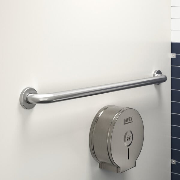 A Lavex 36" restroom grab bar on a wall next to a toilet paper dispenser.