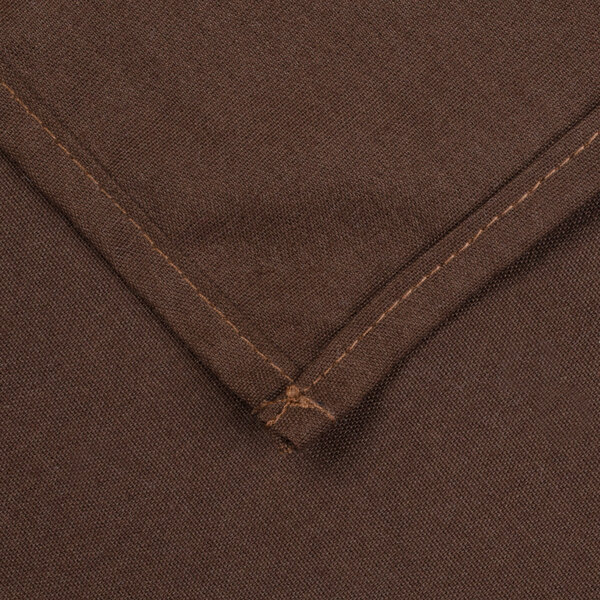 A close-up of a brown cloth table cover with a small hole.