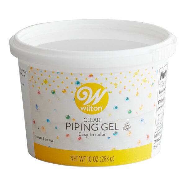 A white plastic tub labeled 'Wilton Clear Piping Gel' with a yellow and white design and a net weight of 10 oz (283 g).
