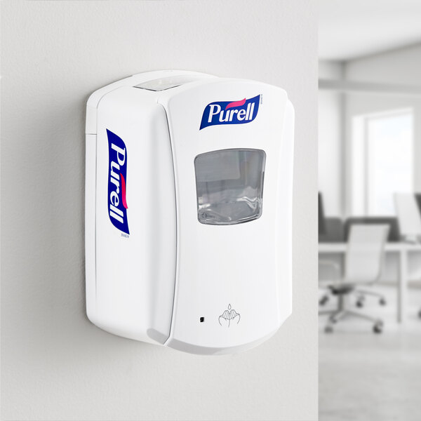 A white Purell touchless hand sanitizer dispenser with a clear plastic window.