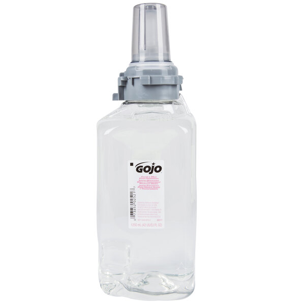 A clear plastic bottle of GOJO clear & mild foaming hand soap with a silver lid.
