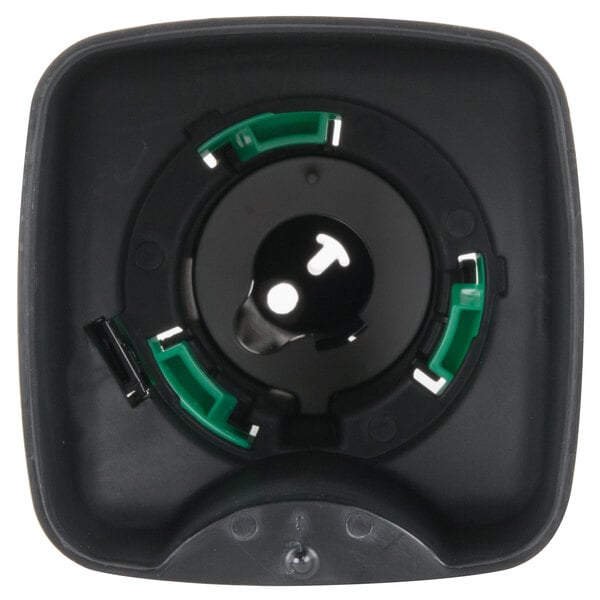 A close-up of a black and green GOJO manual foaming soap dispenser with green and white accents.