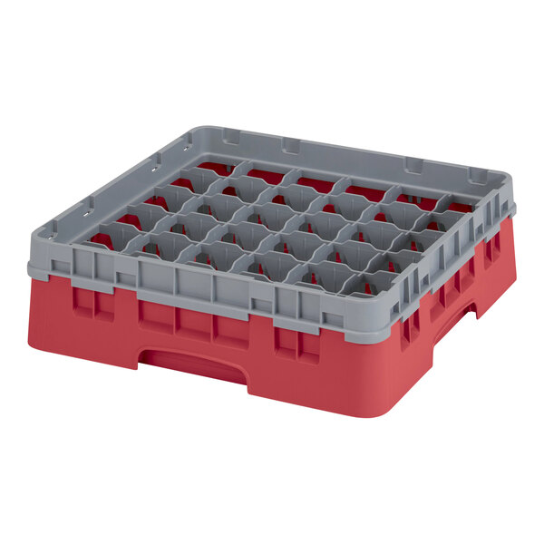 A red plastic Cambro glass rack with several compartments and a grey extender.