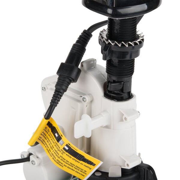 A chrome GOJO CXi touchless soap dispenser with a yellow cord.