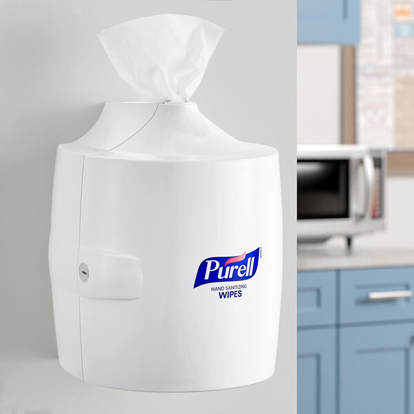 A white Purell wall dispenser with a handle.