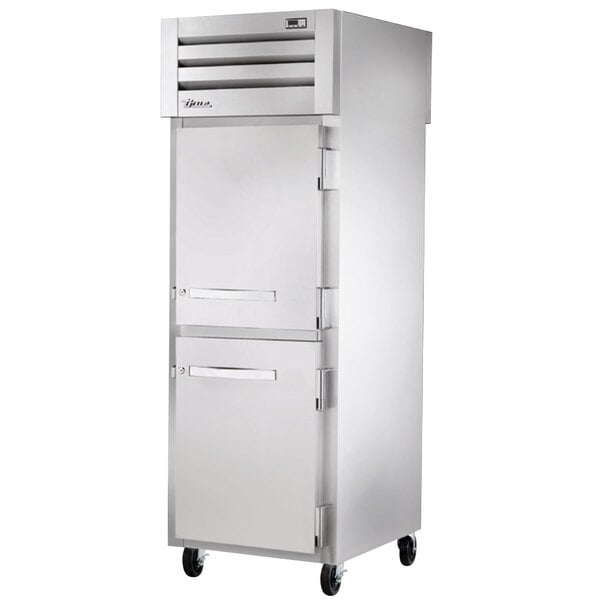 A white True pass-through freezer with silver handles on the doors.