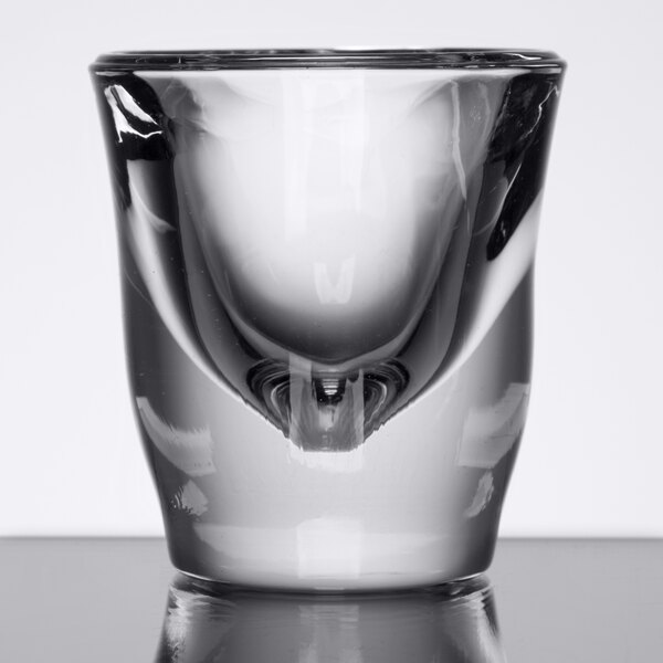 A close-up of a clear Anchor Hocking shot glass.