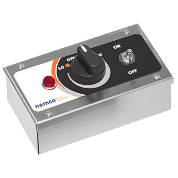 A silver box with a black dial and a red button.