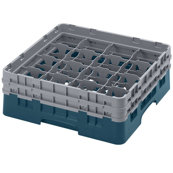 A teal plastic Cambro glass rack with 16 compartments and 2 extenders.