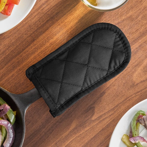 A black quilted cotton pot or pan handle cover.