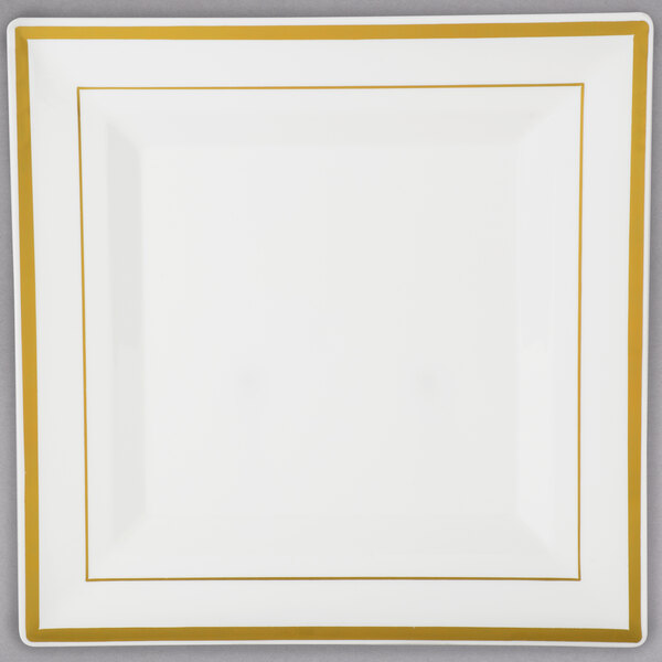 A Fineline Silver Splendor white plastic square plate with gold bands.