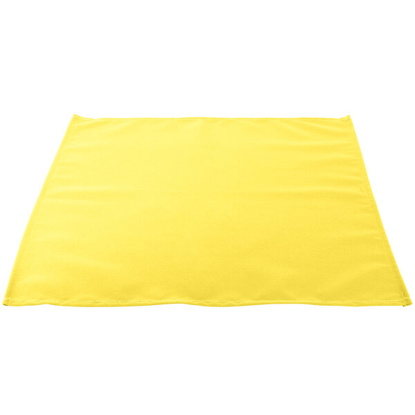 A yellow Intedge cloth napkin on a white background.