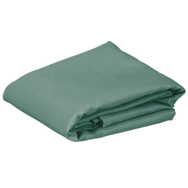A folded seafoam green rectangular table cover.