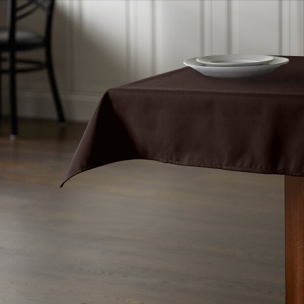 A brown Intedge square tablecloth on a restaurant table.