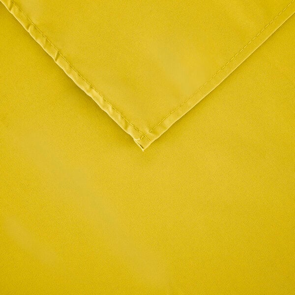 A yellow rectangular table cover with a folded edge.