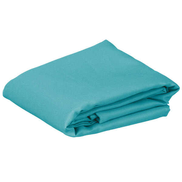 A folded teal rectangular cloth table cover.