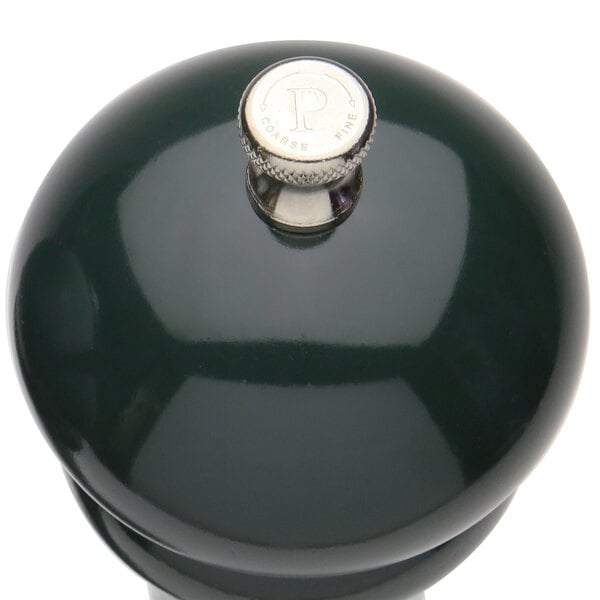A Chef Specialties forest green pepper mill with a silver knob.