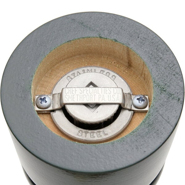 A close-up of the Chef Specialties Autumn Hues Forest Green Pepper Mill and Salt Mill Set's metal grinder and knob.