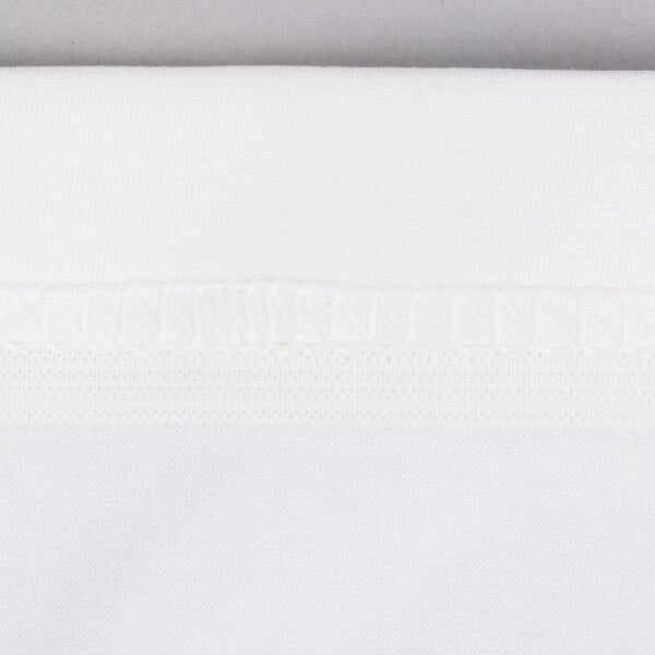 A close up of a white Snap Drape Contour Table Cover with a white border.